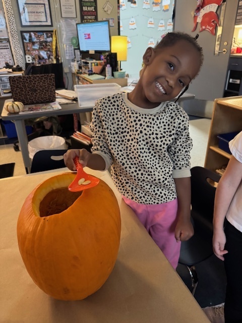 Pumpkin carving in Pre-K, Mrs. Beach