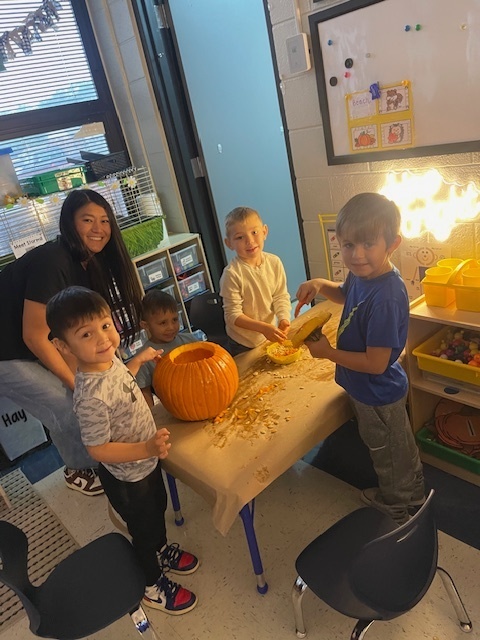 Pumpkin carving in Pre-K, Mrs. Beach