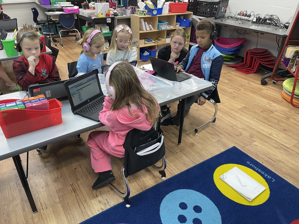 Some of Covey's 3rd graders helping Graves 1st graders with coding. 
