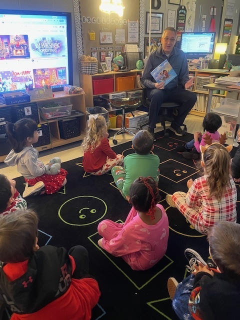 Mr. Miller reads to Mrs. Beach's class