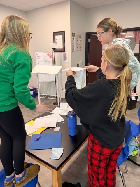 Student's building a paper tower