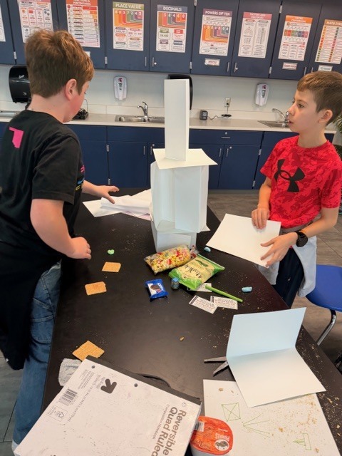 Student's building a paper tower