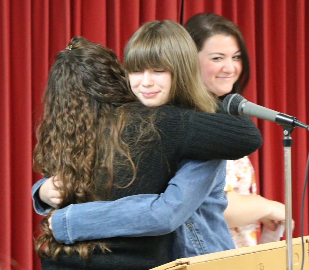 Olivia Adams receives a hug from her teacher Jessica Dunica during the Jennerjahn Most Improved Student Banquet