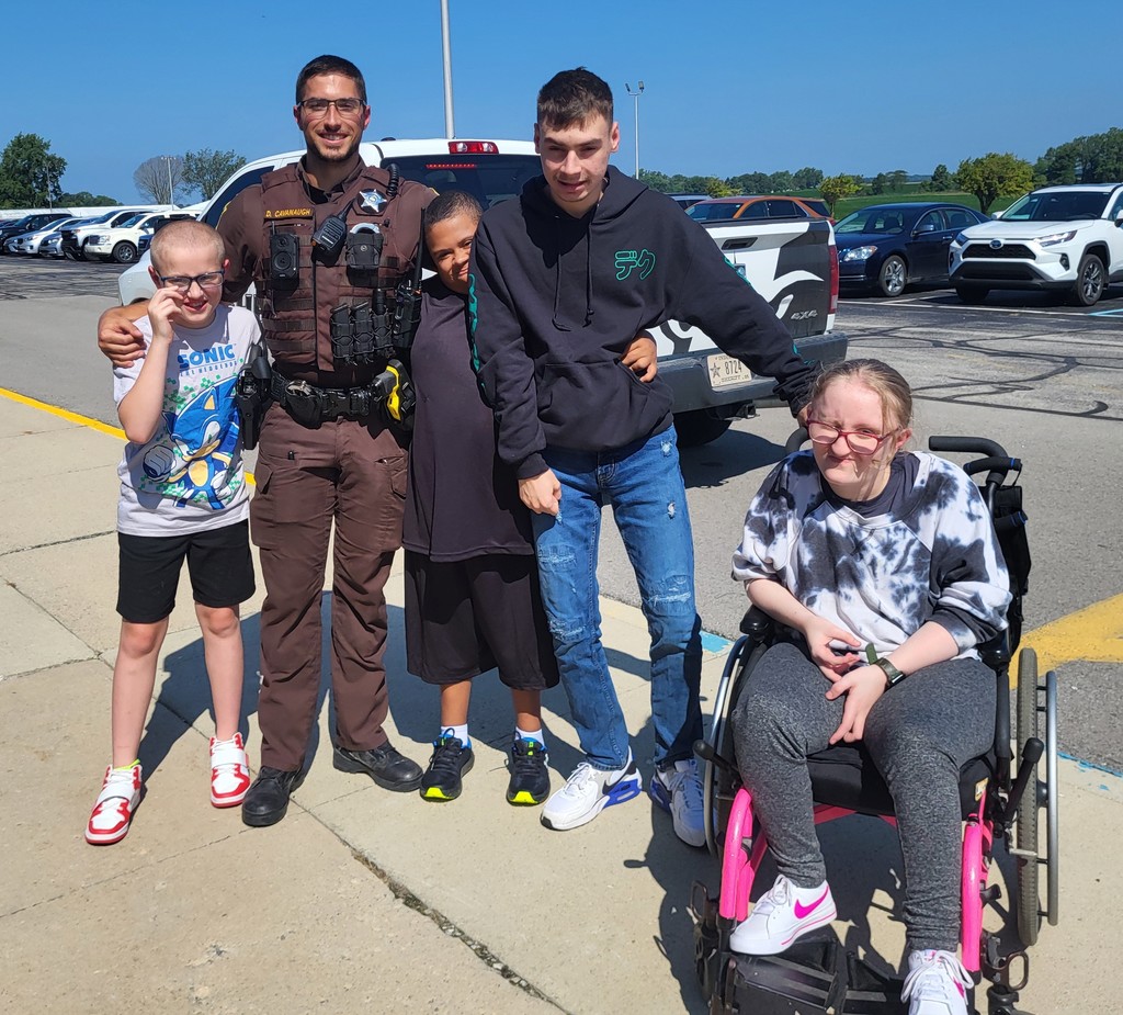 Students in Mrs. Wallace's class learn about Officer Cavanaugh's gear and vehicle.