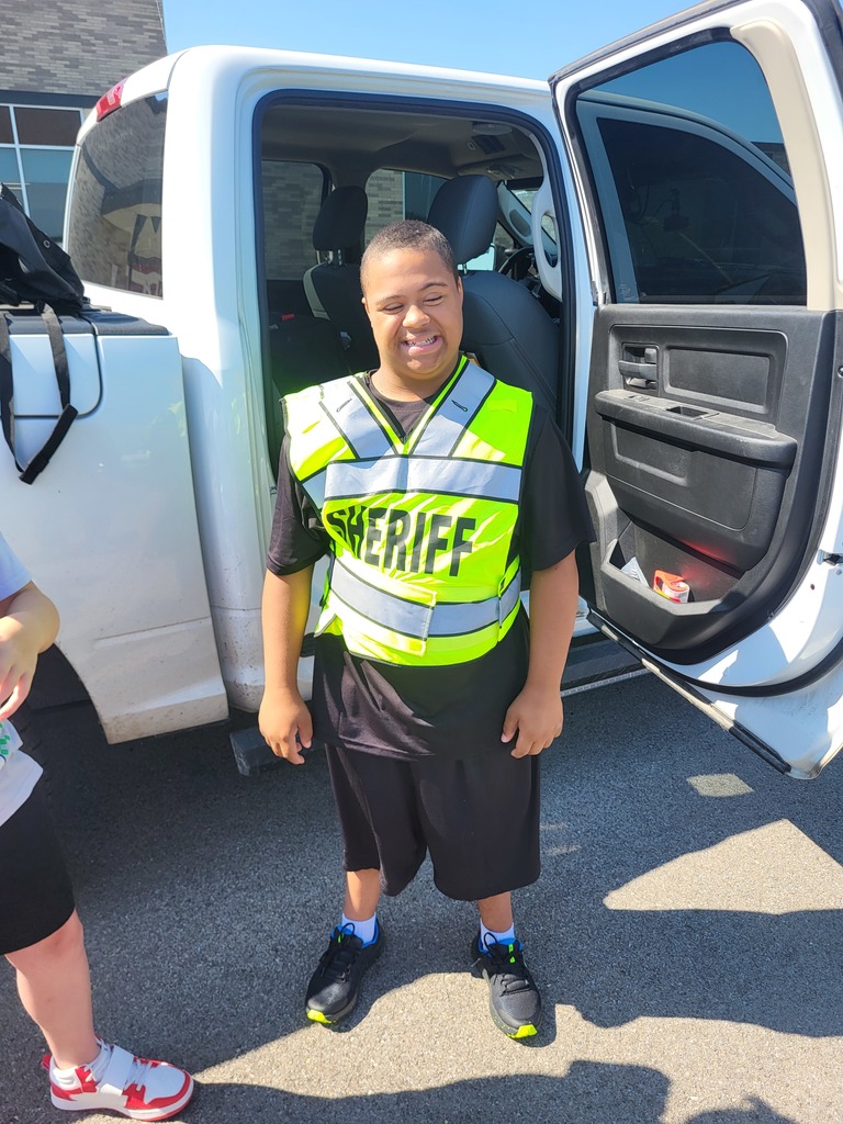 Students in Mrs. Wallace's class learn about Officer Cavanaugh's gear and vehicle.