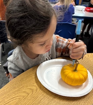 BPS Preschool students decorate pumpkins during their Fun Fall Party