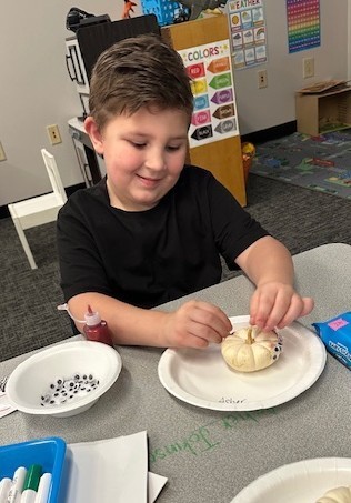 BPS Preschool students decorate pumpkins during their Fun Fall Party