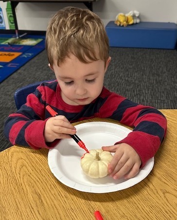 BPS Preschool students decorate pumpkins during their Fun Fall Party
