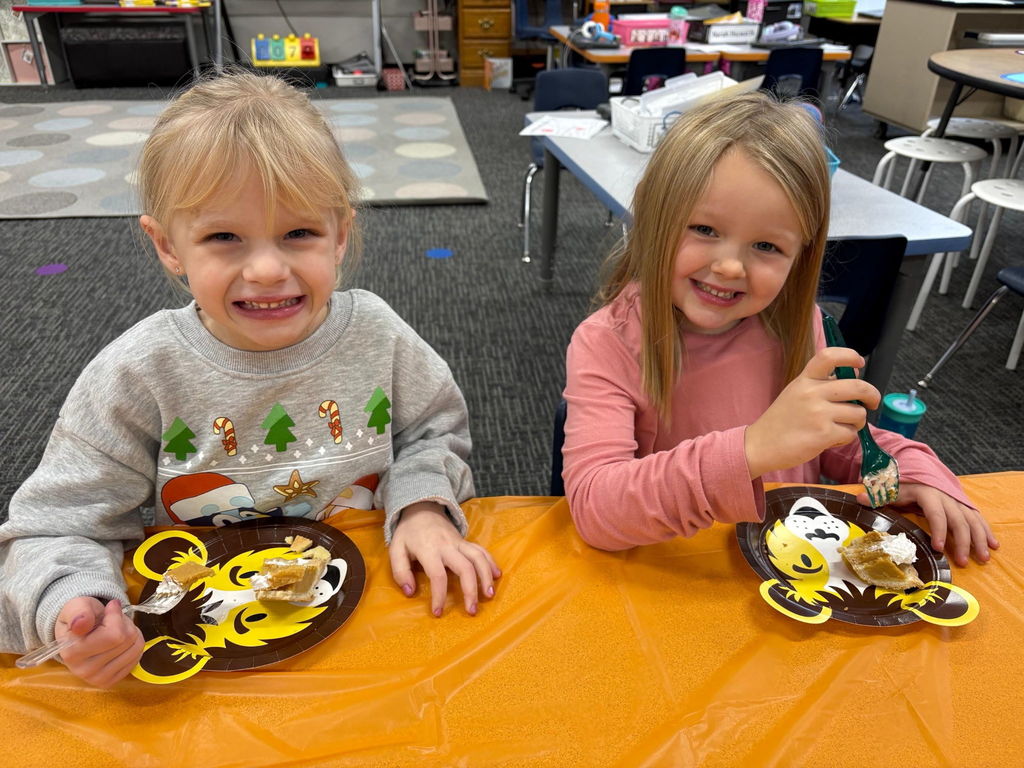 Kindergarten students celebrate the Thanksgiving holiday with a piece of pie