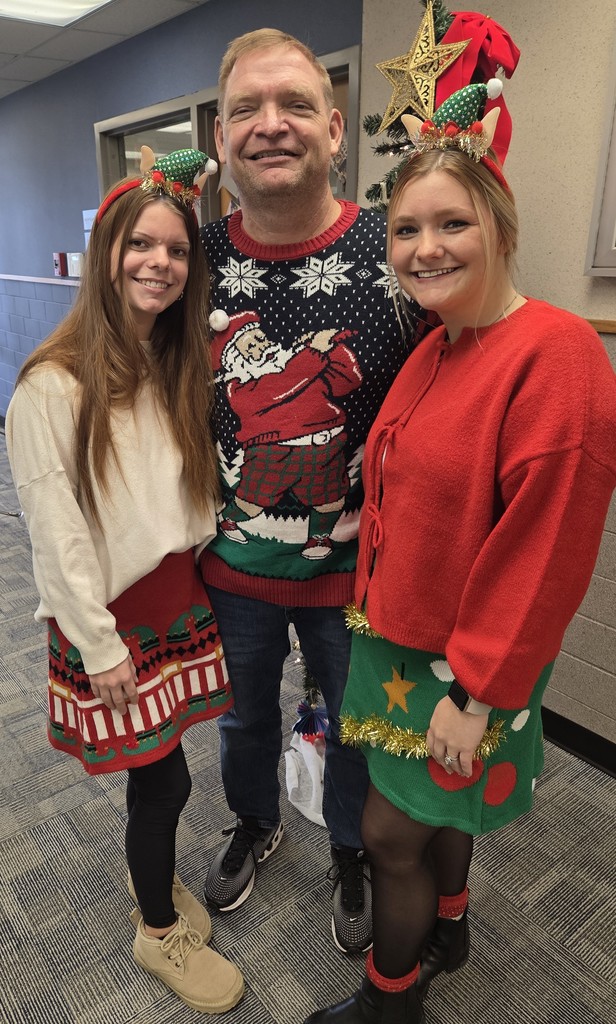 Superintendent Yencer,  joined by daughters Jadyn and Jessica, distribute candy canes to BCS elementary students
