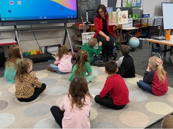 Assistant Superintendent Lesley Moulton reads to elementary students throughout the district