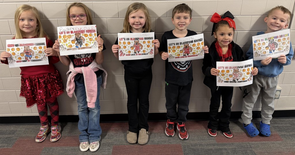 Kindergarten students color pictures to wish the Bruins luck at Regionals