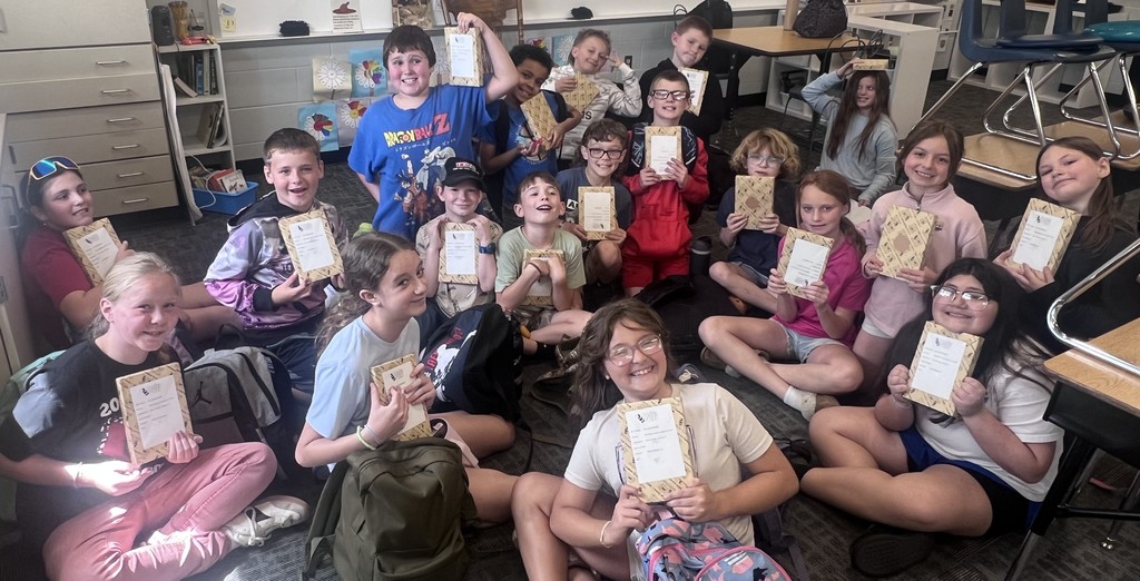 BIS students celebrate the completion of their fundraiser with new books to read!
