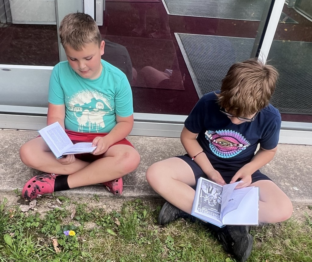 BIS students celebrate the completion of their fundraiser with new books to read!