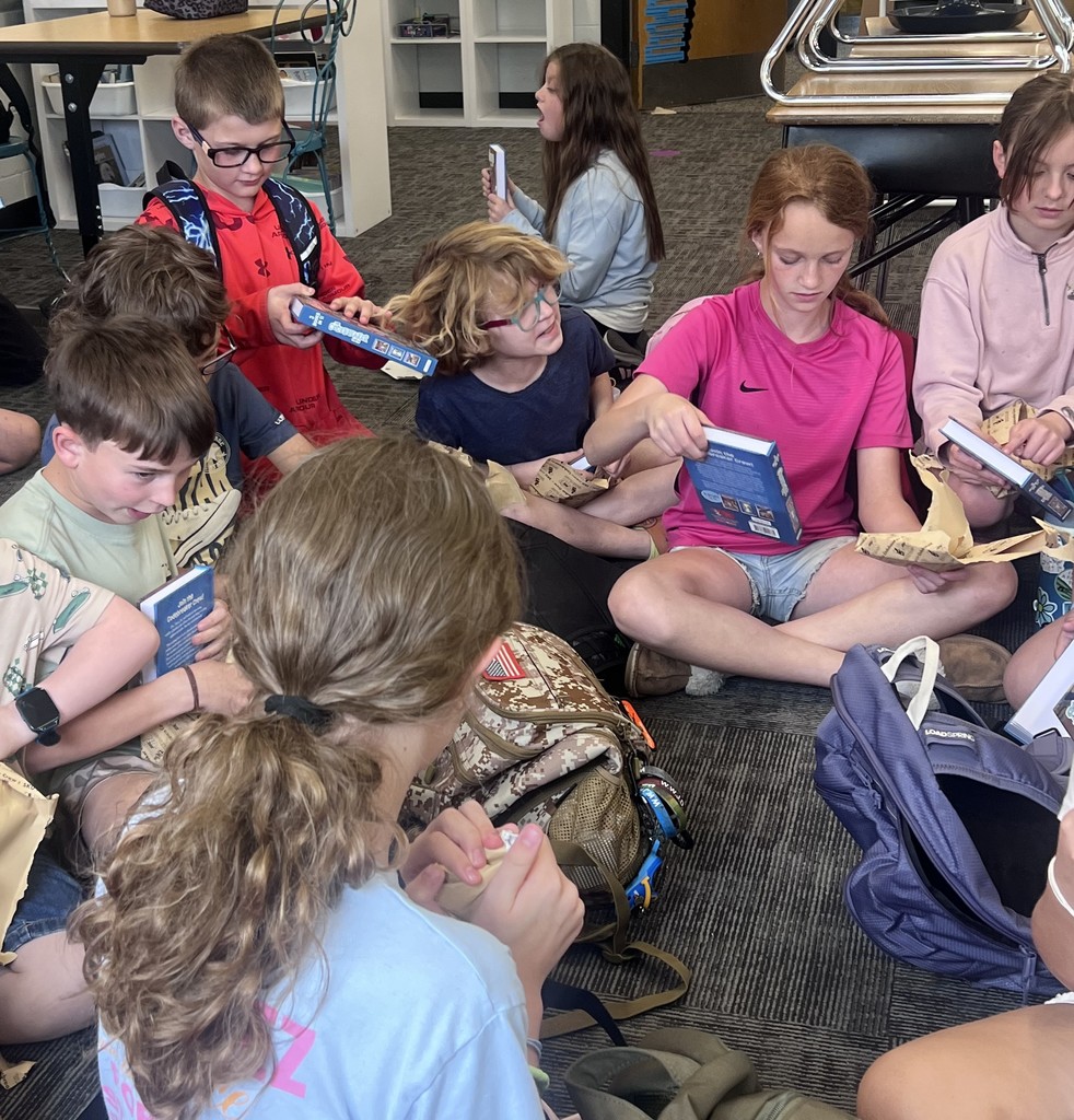 BIS students celebrate the completion of their fundraiser with new books to read!