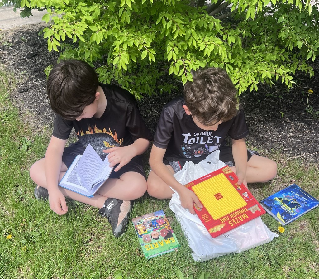 BIS students celebrate the completion of their fundraiser with new books to read!