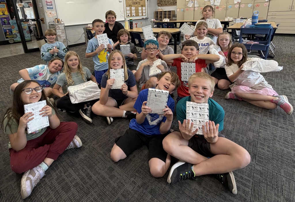 BIS students celebrate the completion of their fundraiser with new books to read!