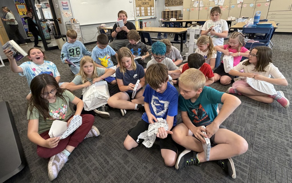 BIS students celebrate the completion of their fundraiser with new books to read!