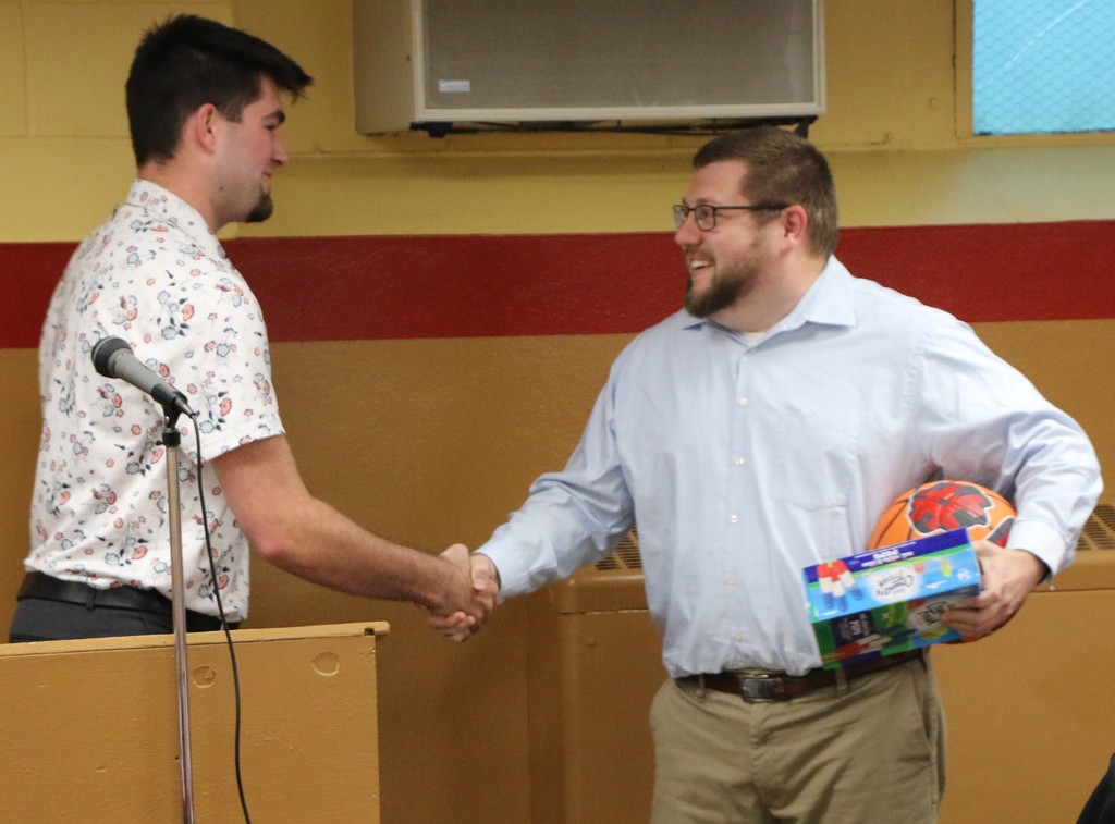 Mason Kitterman presents gifts to his Jennerjahn Most Influential Educator (and coach) Garrett Krieg. 