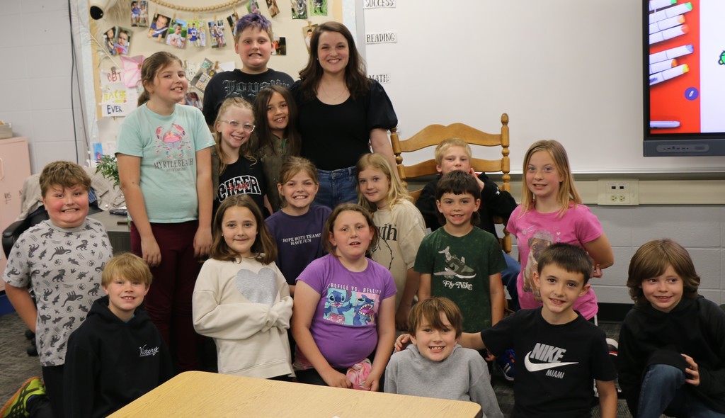 BIS Teacher of the Year Rachael Shadiow is surrounded by her very excited class