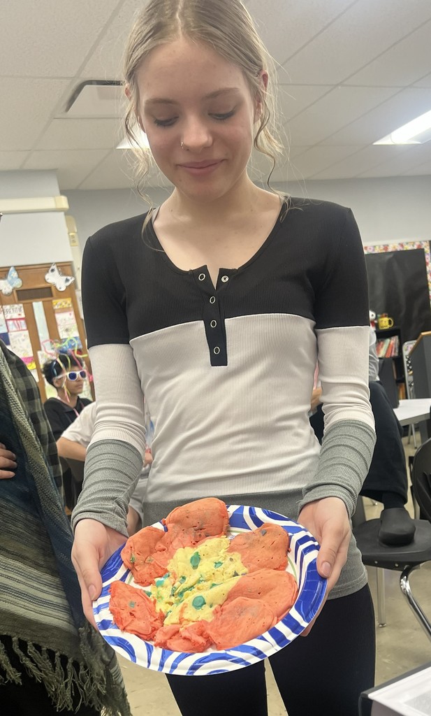 A BJSHS 7th or 8th grade girl shows her pancake art in the shape of a flower