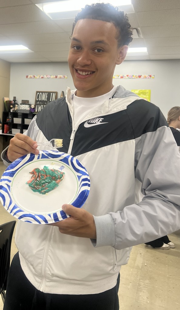 A BJSHS 7th or 8th grade boy shows off his pancake art