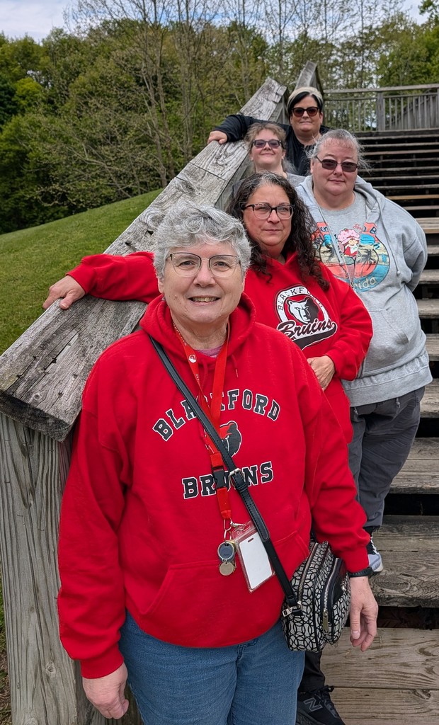 Mrs. Linda Wallace and her staff of 4 assistants stand on stairs for a photo at the Gas City Park during a field trip.