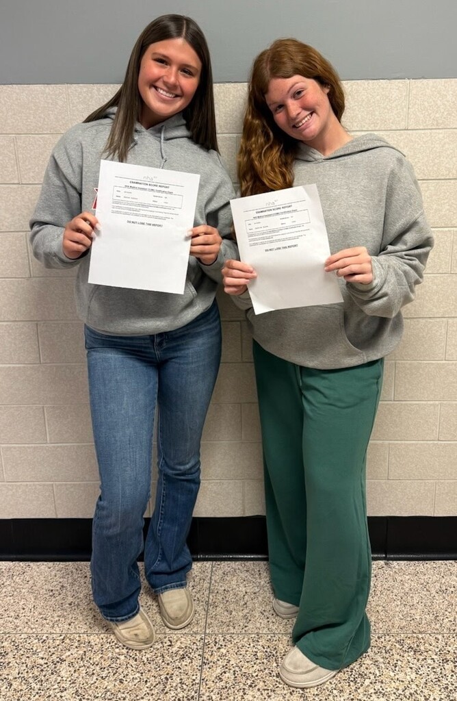 Two BJSHS girls hold their CNA certificates