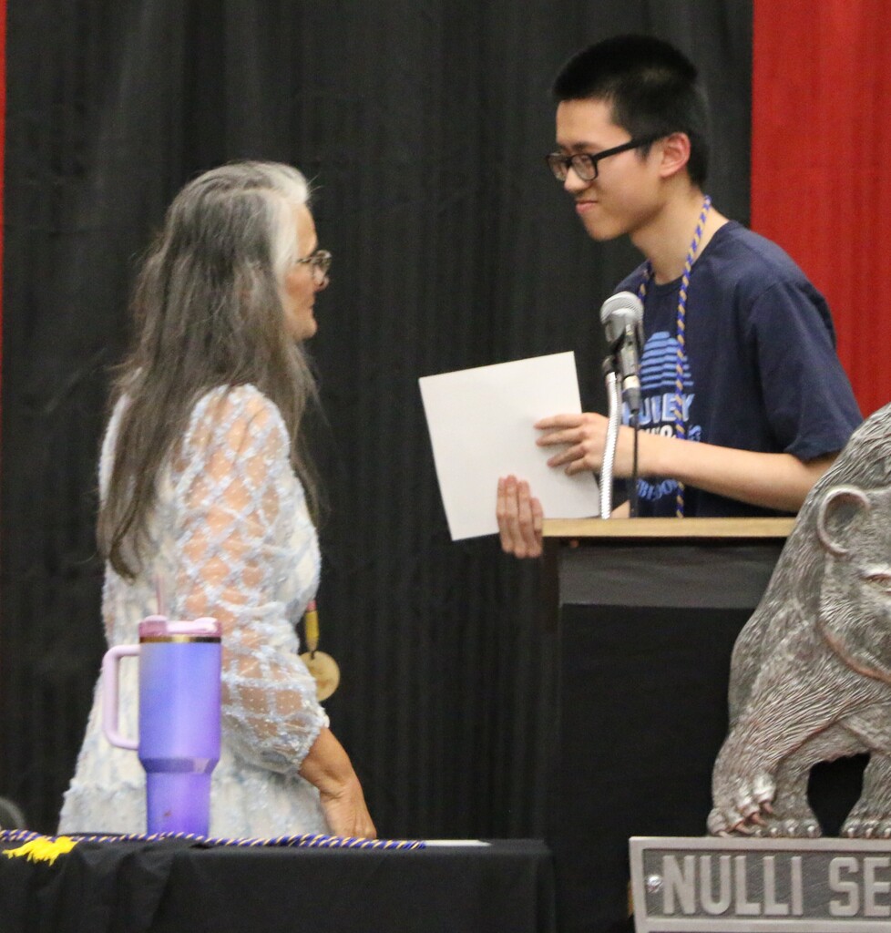 Mrs. Carrie Clevenger presents a Certificate of Multilingual Proficiency to BJSHS senior Raymond Chen.