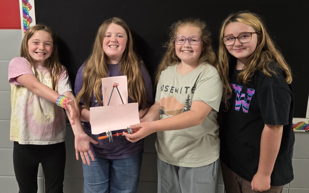 4 4th grade girls from BIS display the winning car that they made and raced