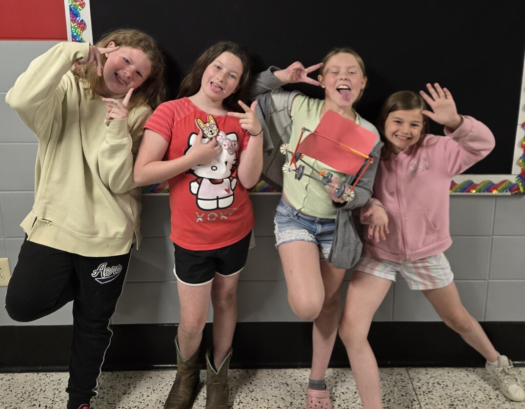 4 4th grade girls from BIS display the winning car that they made and raced