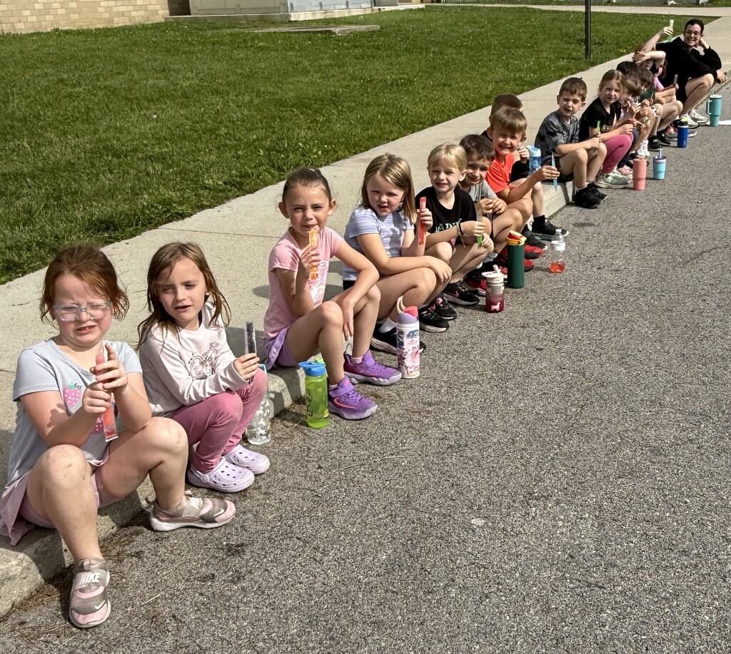 BPS students eat popsicles during the End of School Year Field Day