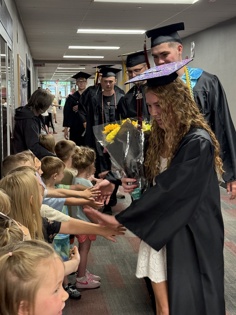 BJSHS seniors walk in their caps and gowns down the halls of BPS and BIS