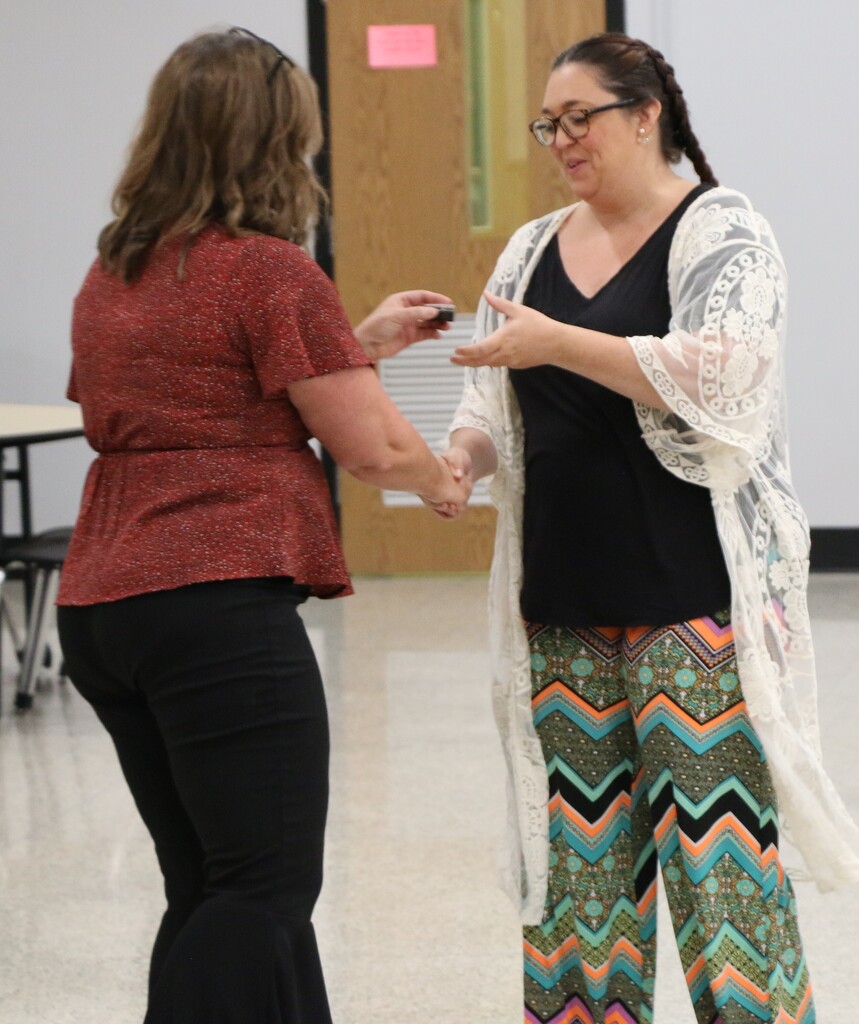 Assistant Superintendent Lesley Moulton presents a service pin to Rachael Story