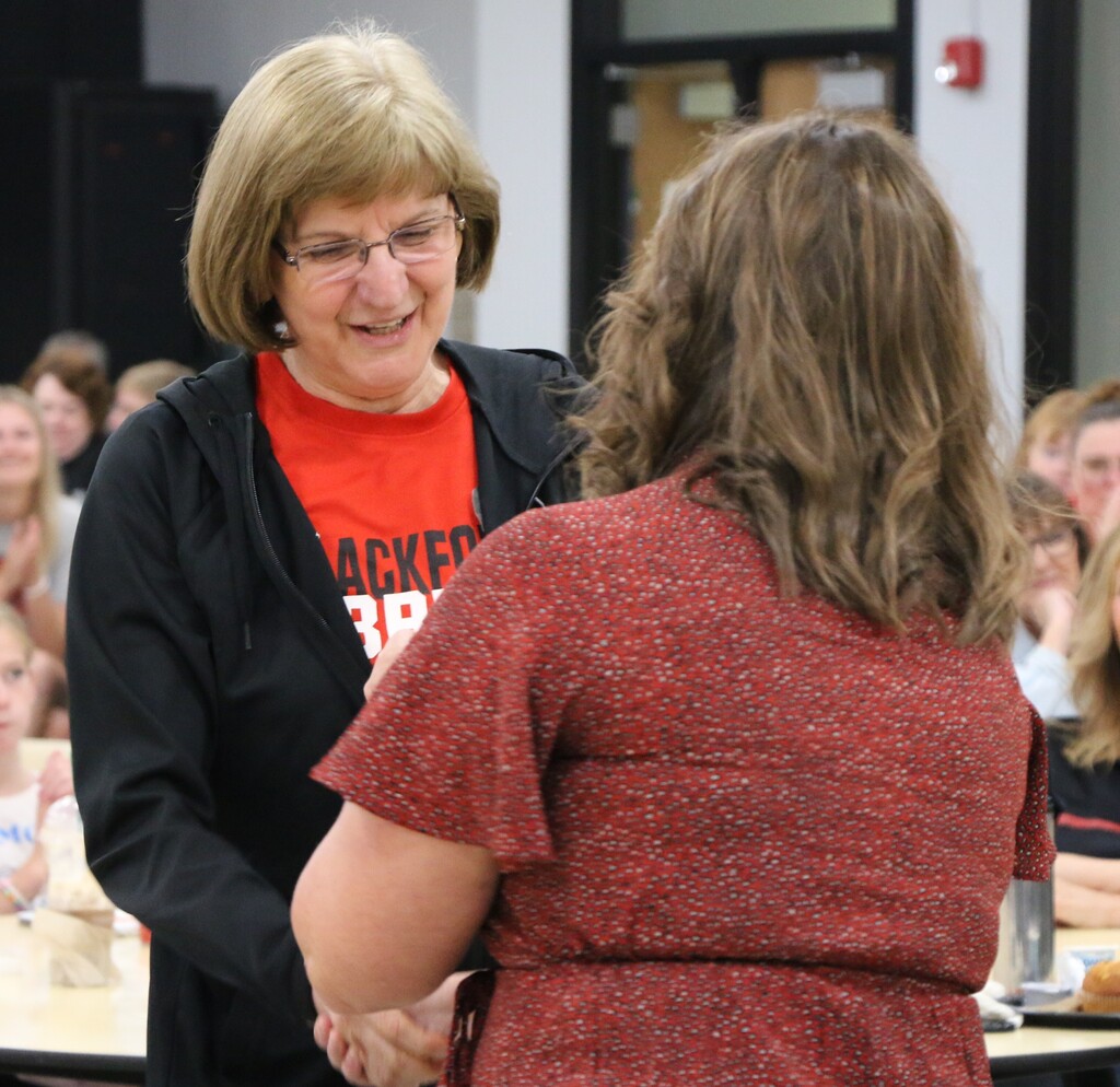 BCS Assistant Superintendent Lesley Moulson presents a 31 year service pin to BJSHS teacher Sherri Barker