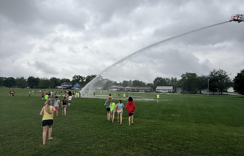 BIS students play in water (provided by the Hartford City Fire Department) during their Field Day