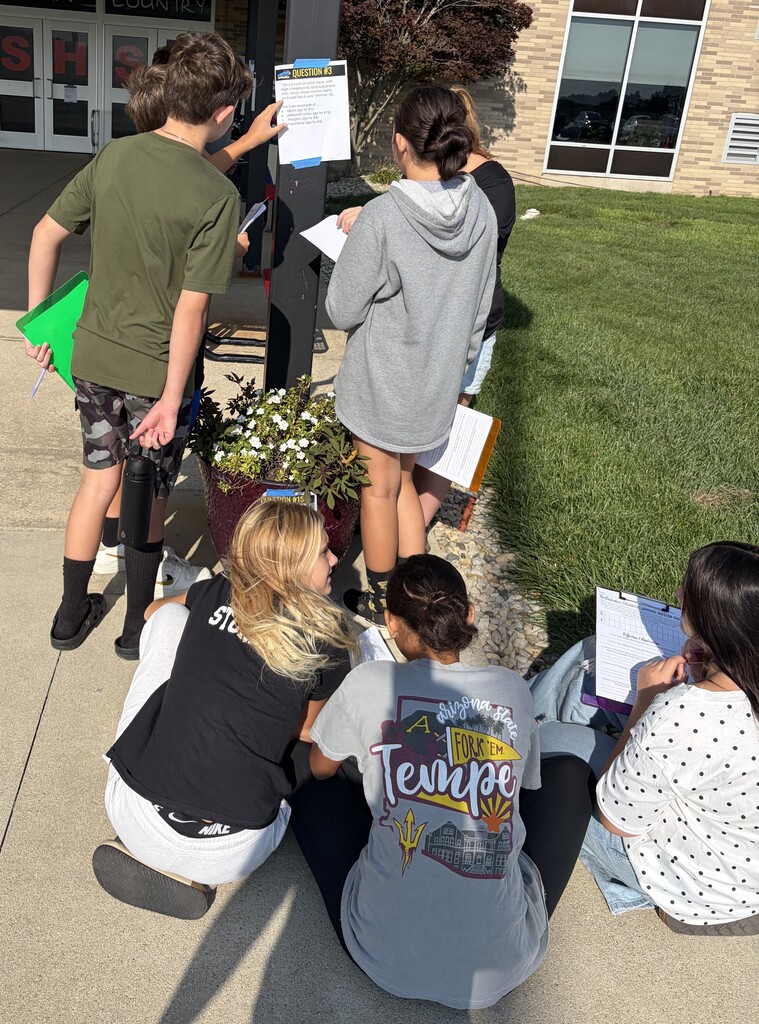 7th grade students work on a scavenger hunt using passages from The Outsiders