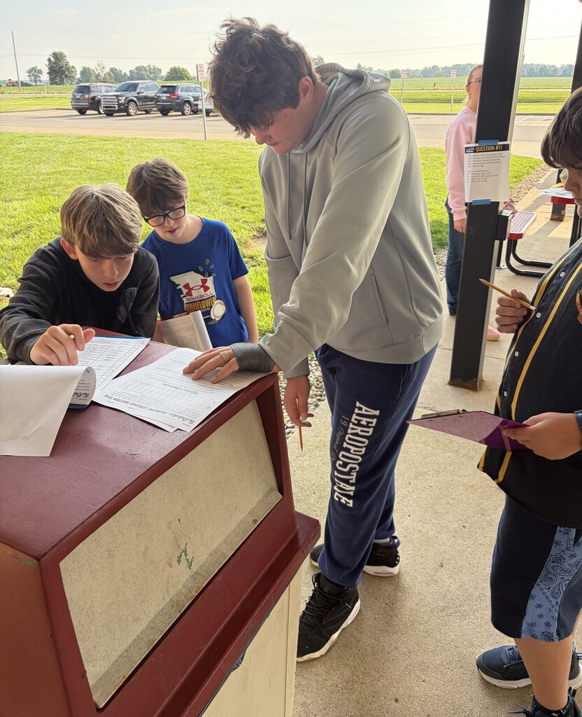 7th grade students work on a scavenger hunt using passages from The Outsiders