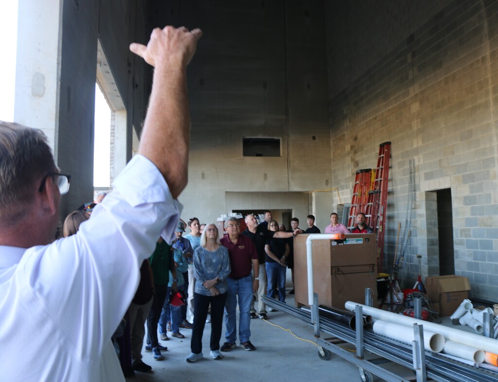 Superintendent Chad Yencer gestures to the ceiling of the BJSHS PAC