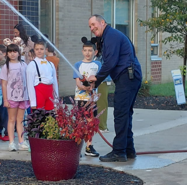 A boy took turns holding the fireman's fire hose during fire safety lessons at BPS