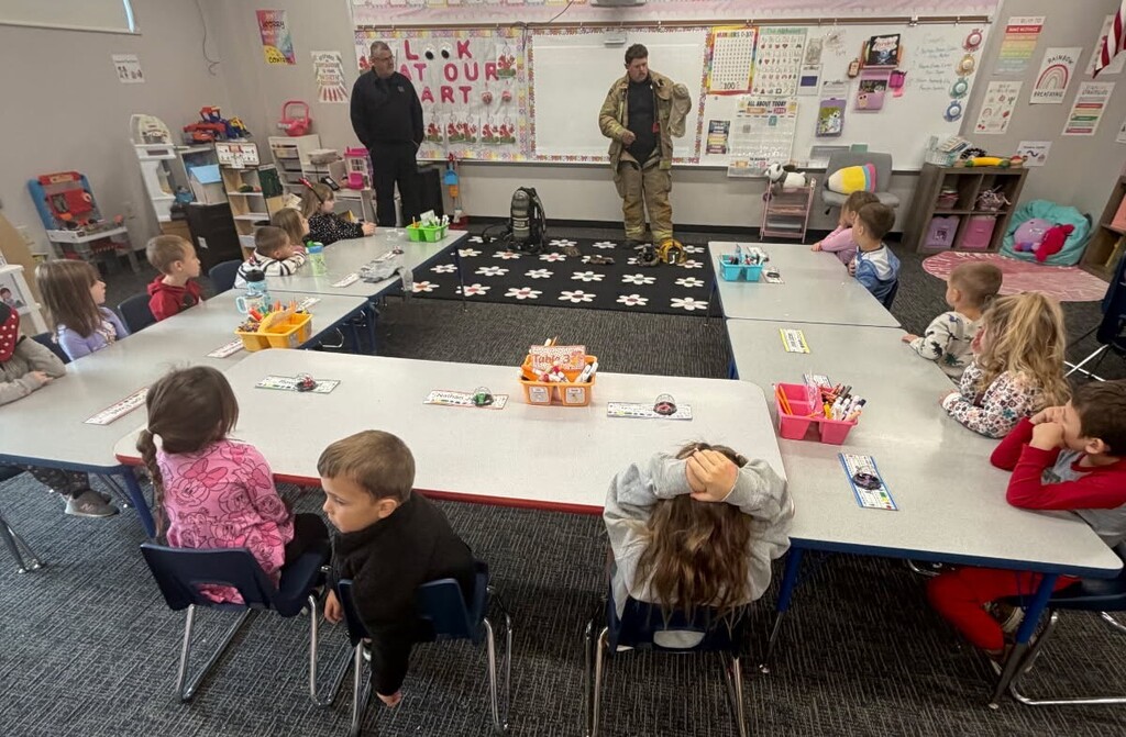 Two fireman from Hartford City Fire Dept. stand in front of elementary students at BPS