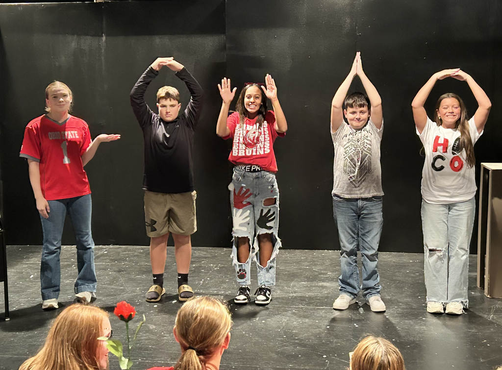 Four BJSHS 7th grade students spell O-H-I-O while guest speaker Chloe Smith talks about life after graduation.