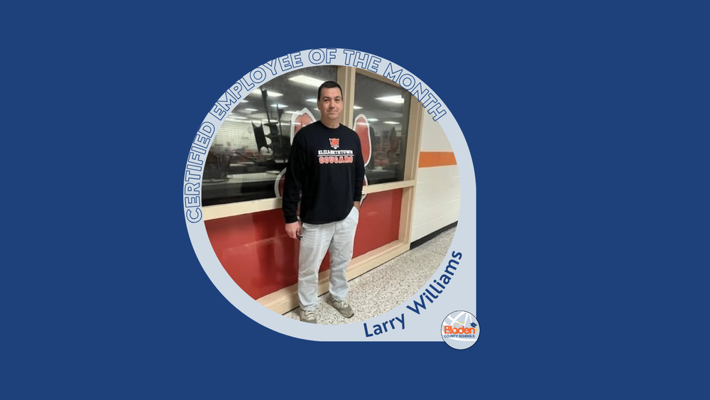 Graphic announcing Certified Employee of the Month featuring Larry Williams, standing in a school hallway in front of a windowed classroom, wearing an Elizabethtown Cougars sweatshirt and light pants, with Bladen County Schools logo.