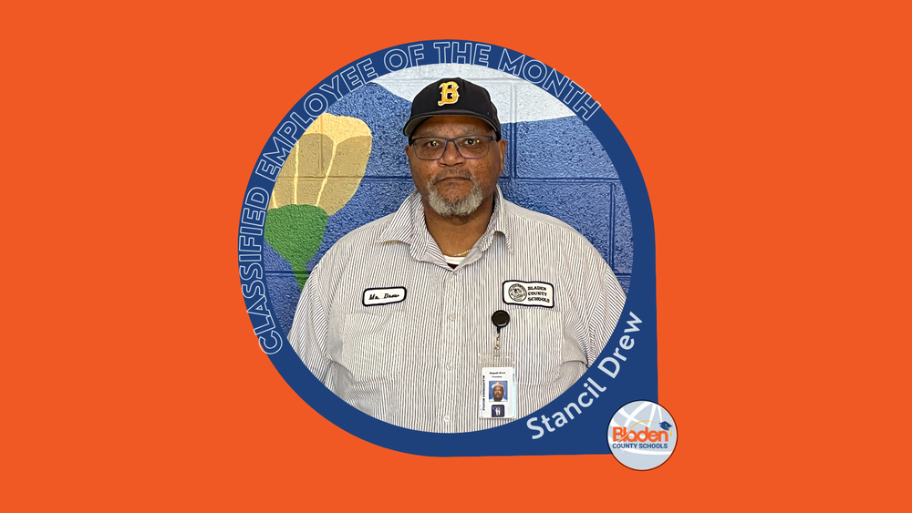 Graphic announcing Classified Employee of the Month featuring Stancil Drew, standing in front of a colorful school mural, wearing a striped work shirt, name badge, and baseball cap, with Bladen County Schools logo.