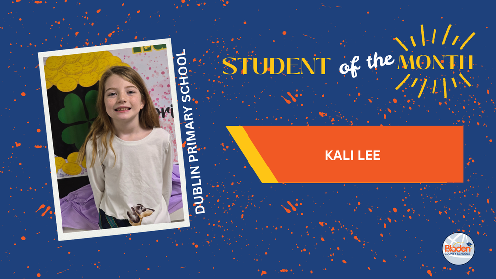 Student of the Month graphic featuring Kali Lee from Dublin Primary School, smiling while standing in front of a colorful classroom display, wearing a light-colored shirt, with bold blue and orange design elements and Bladen County Schools logo.