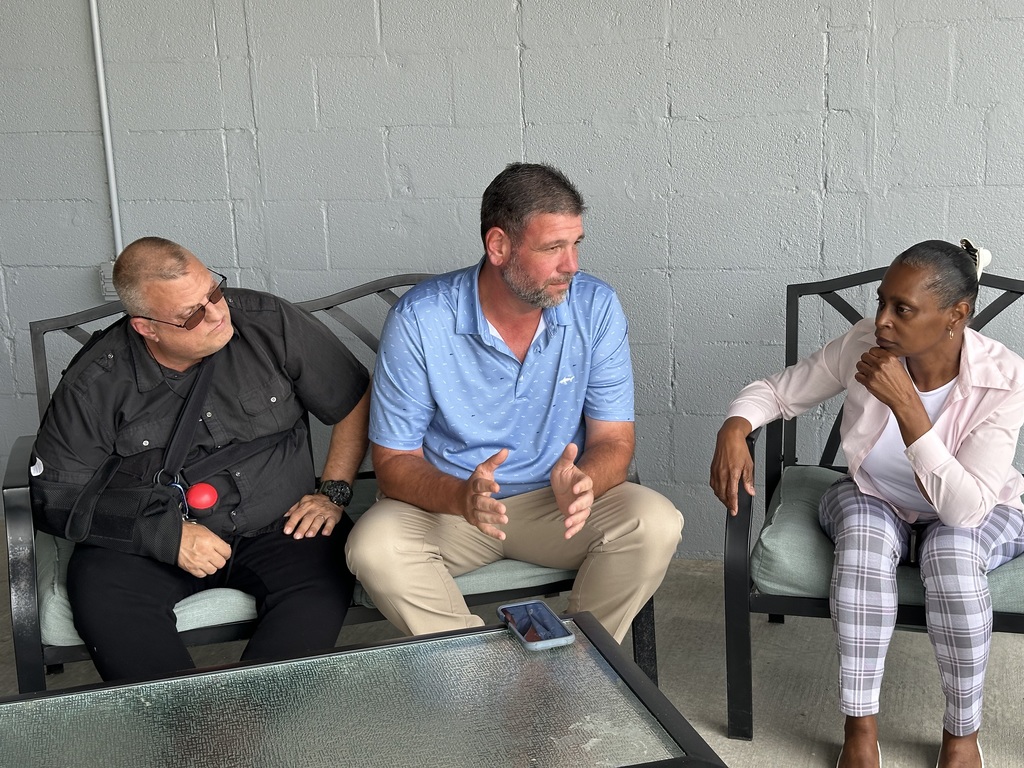 Small group of Elizabethtown Middle School leaders engaged in conversation on an outdoor patio.