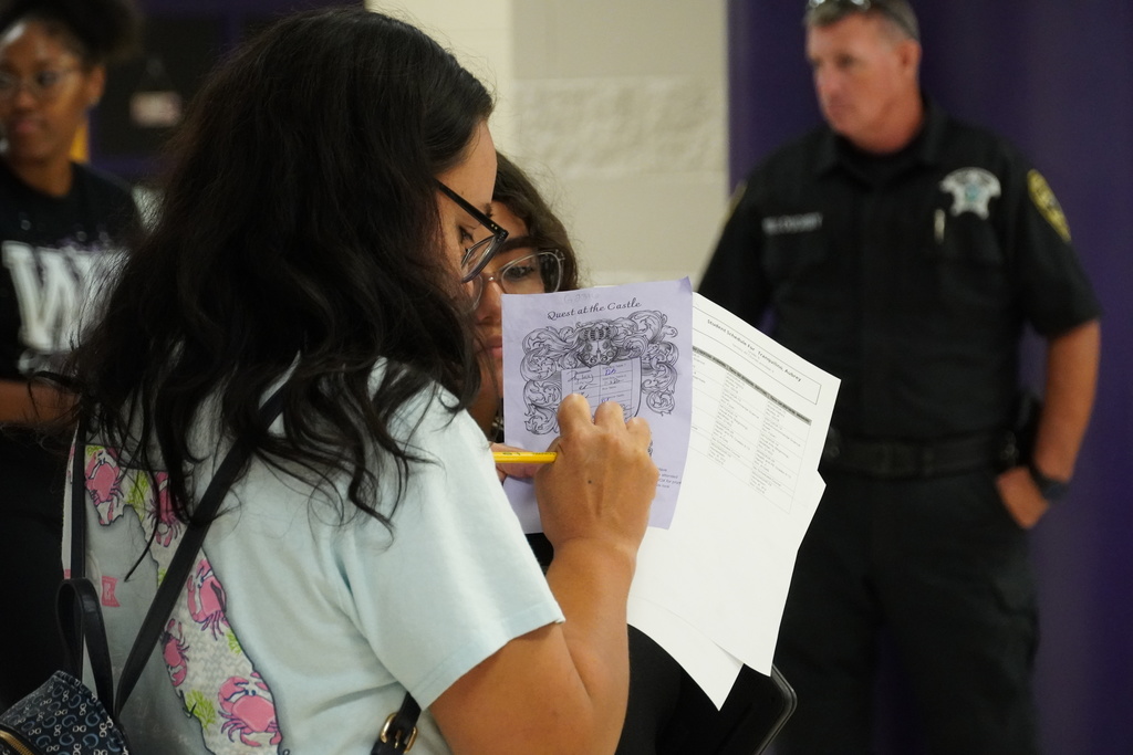 Parent reviews Quest at the Castle sheet with student at West Bladen.