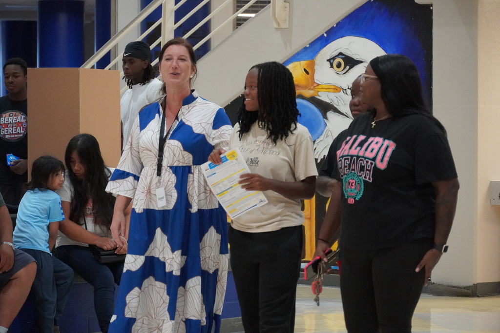 Teacher speaks with students and families during East Bladen orientation.
