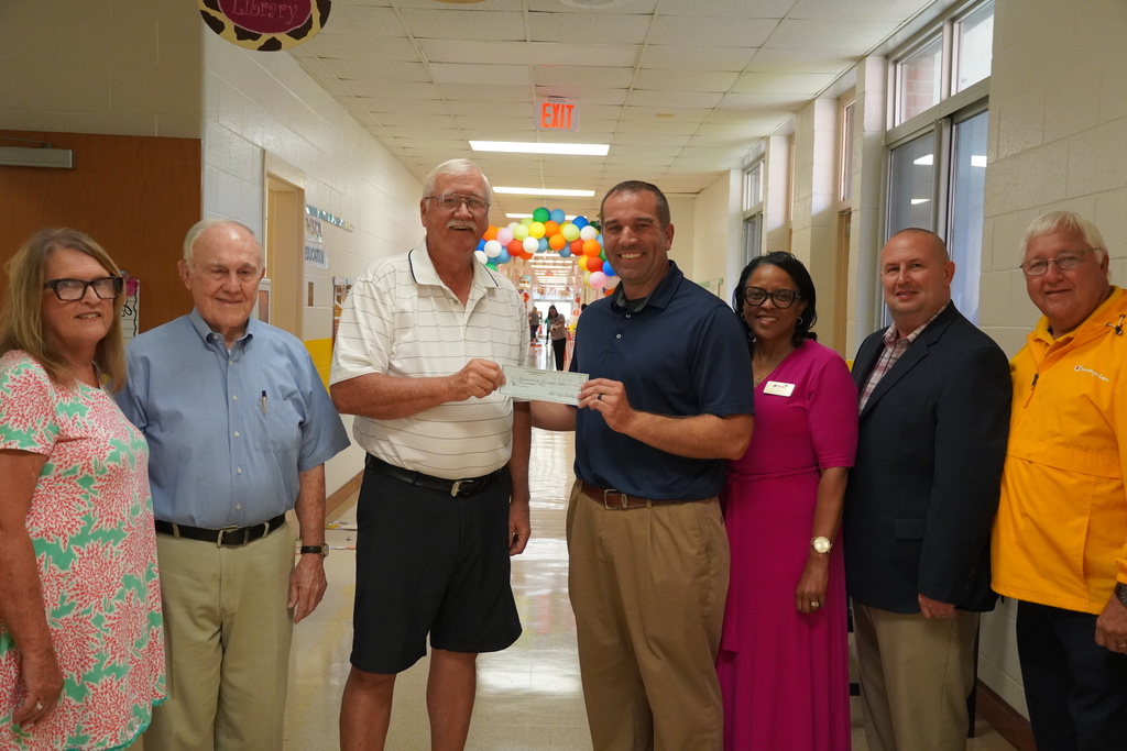 Group photo in school hallway as Bladenboro Rotary presents donation check.