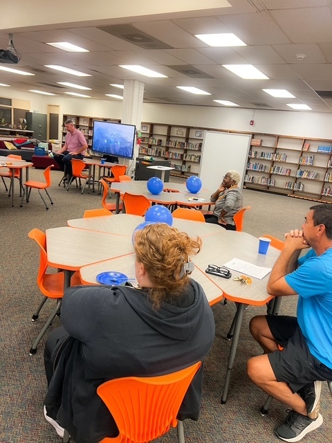 Blue balloons and confetti with text: ‘Today we celebrate with a BLUE party! Elizabethtown Middle School exceeded growth for 2024–2025.’